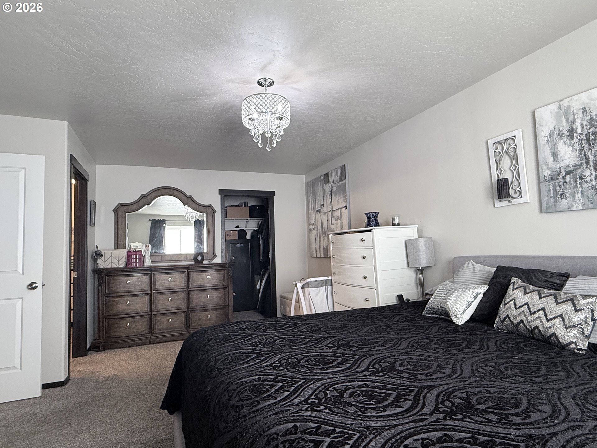472 Cardinal Place Umatilla, OR 97882 - Photo 9 of 28 a bedroom with a bed and a chandelier