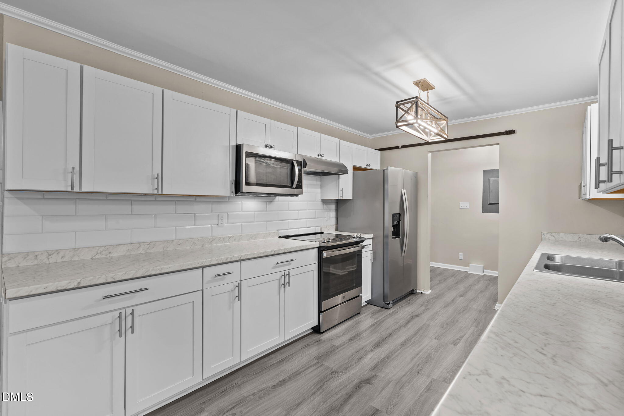 804 West Scotsdale Road Laurinburg, NC 28352 - Photo 13 of 41 a kitchen with stainless steel appliances granite countertop a sink a stove top oven a refrigerator with white cabinets and wooden floor