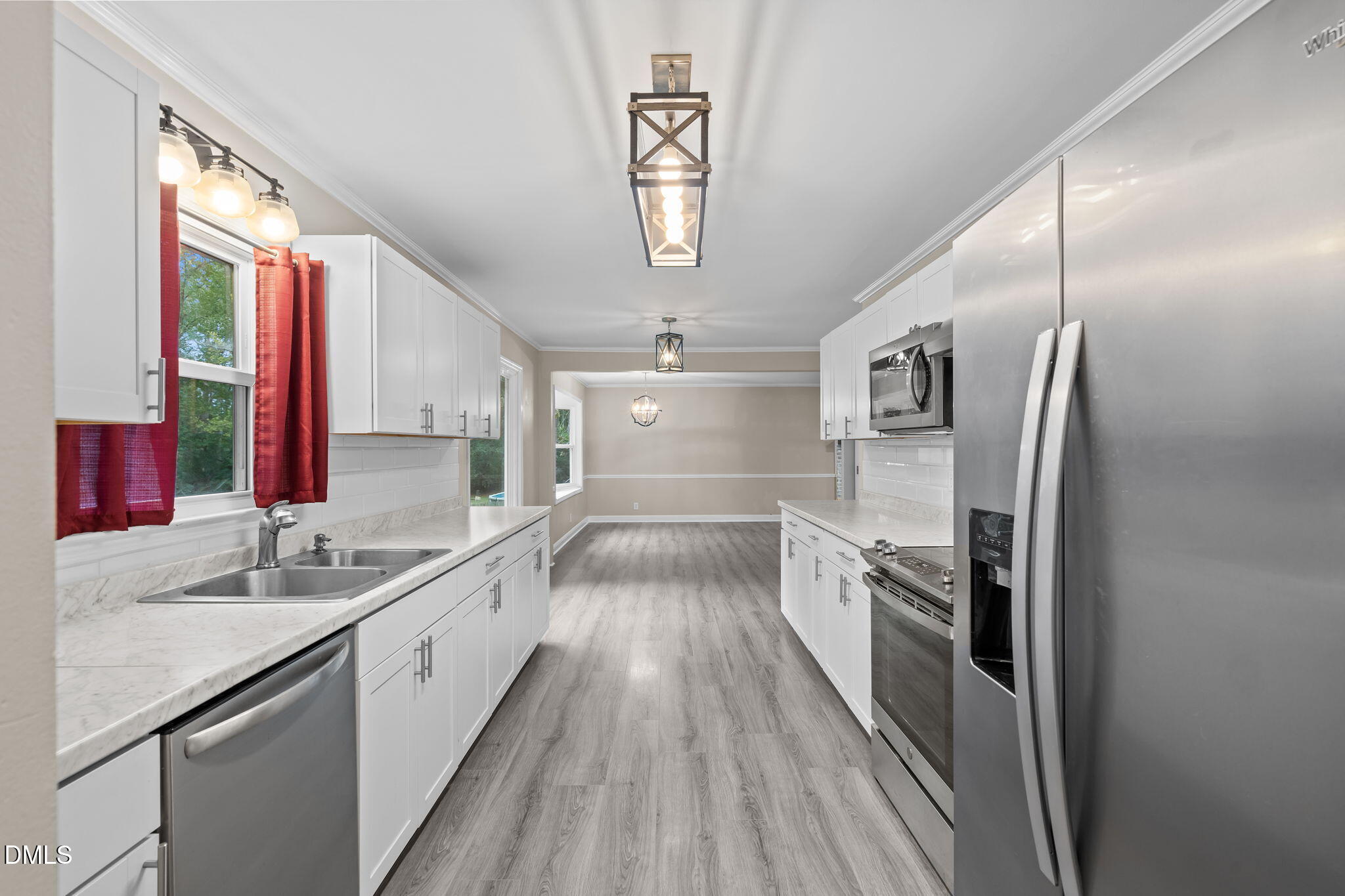 804 West Scotsdale Road Laurinburg, NC 28352 - Photo 16 of 41 a kitchen with stainless steel appliances granite countertop a sink and a refrigerator