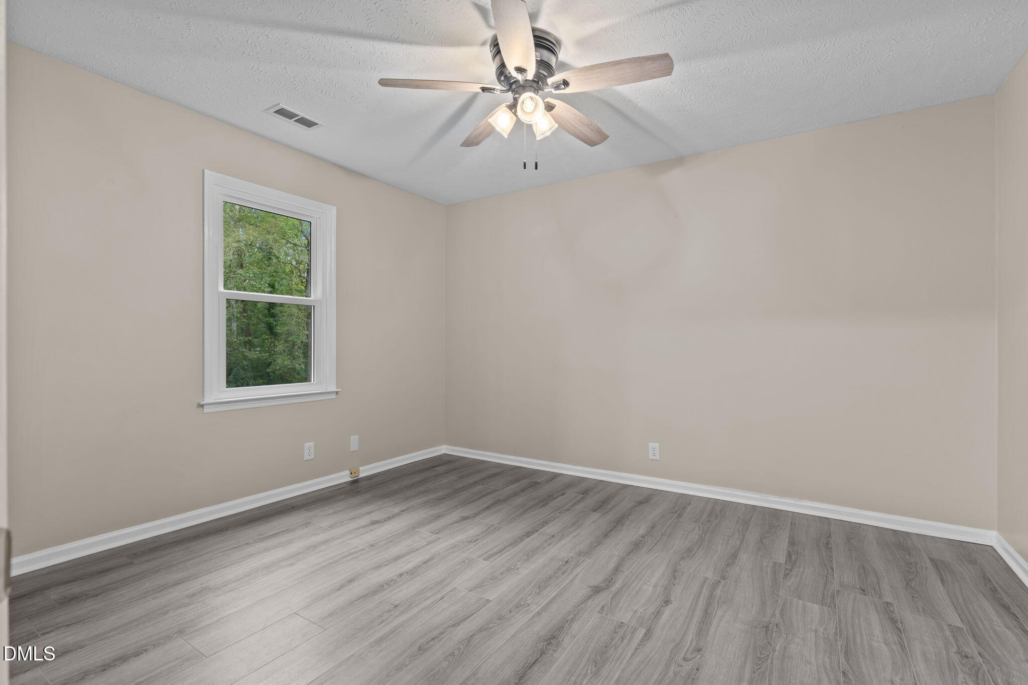 804 West Scotsdale Road Laurinburg, NC 28352 - Photo 27 of 46 wooden floor in an empty room with a window