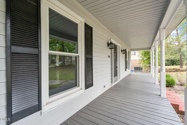a view of backyard with porch and wooden floor