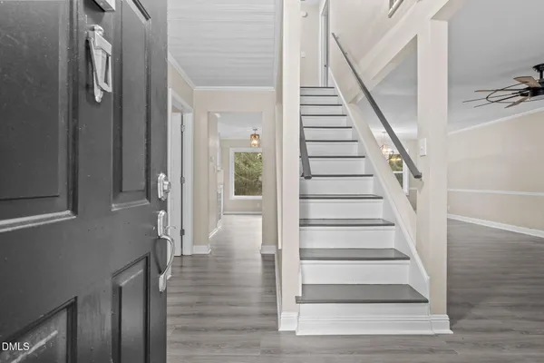 a view of entryway and hall with wooden floor