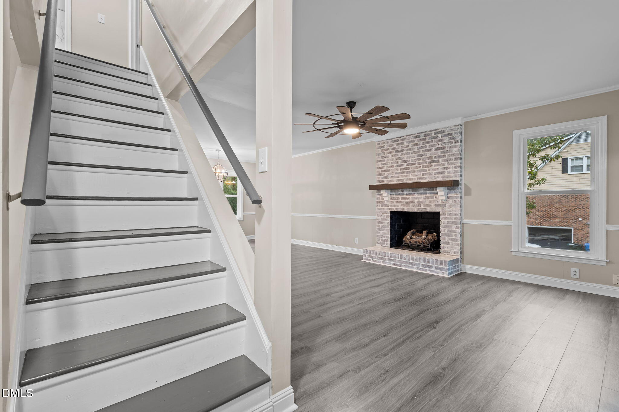 804 West Scotsdale Road Laurinburg, NC 28352 - Photo 7 of 41 a view of an empty room with wooden floor fireplace and a window