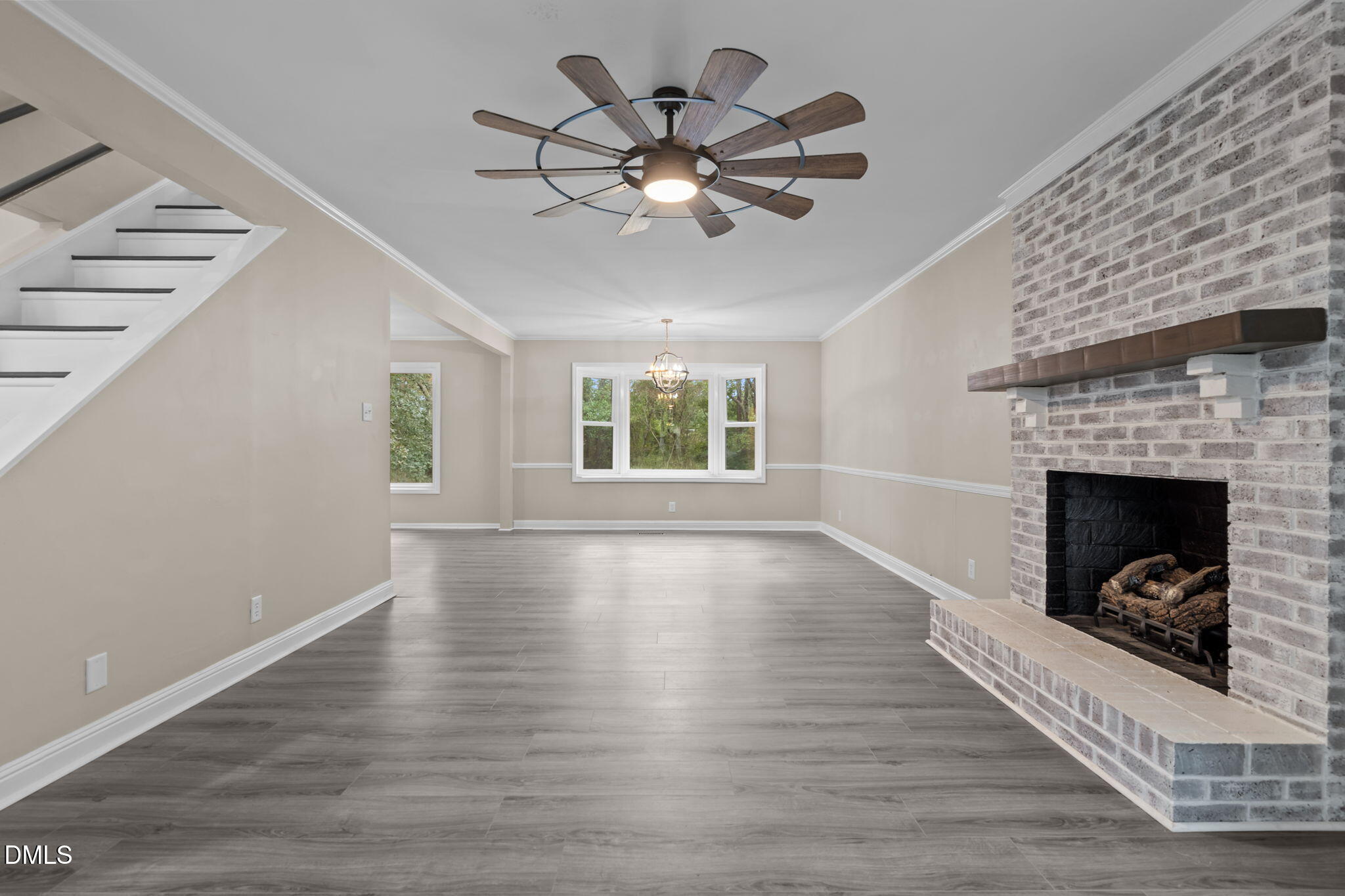 804 West Scotsdale Road Laurinburg, NC 28352 - Photo 9 of 41 a view of a livingroom with a fireplace a ceiling fan and wooden floor