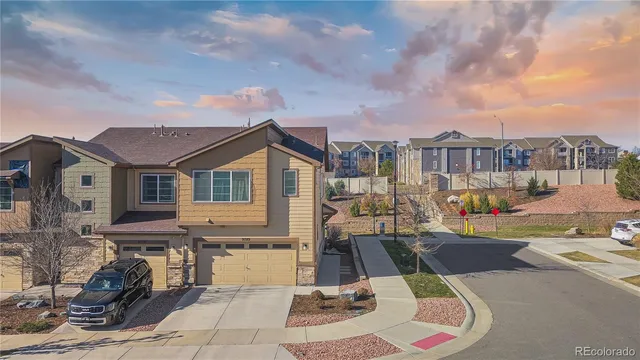 a view of a patio with couches table and chairs and potted plants