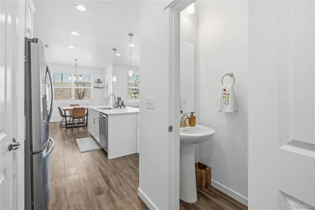 a kitchen with stainless steel appliances sink stove microwave and cabinets