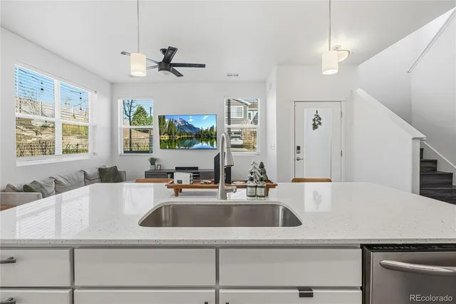 a kitchen with a sink a counter top space and windows