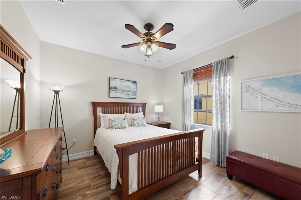 9076 Rialto Street, Unit 6204 Naples, FL 34113 - Photo 25 of 50 Secondary bedroom with neutral wall paint and wood-finish tile flooring define this space. NEW TILE FLOOR (2018)