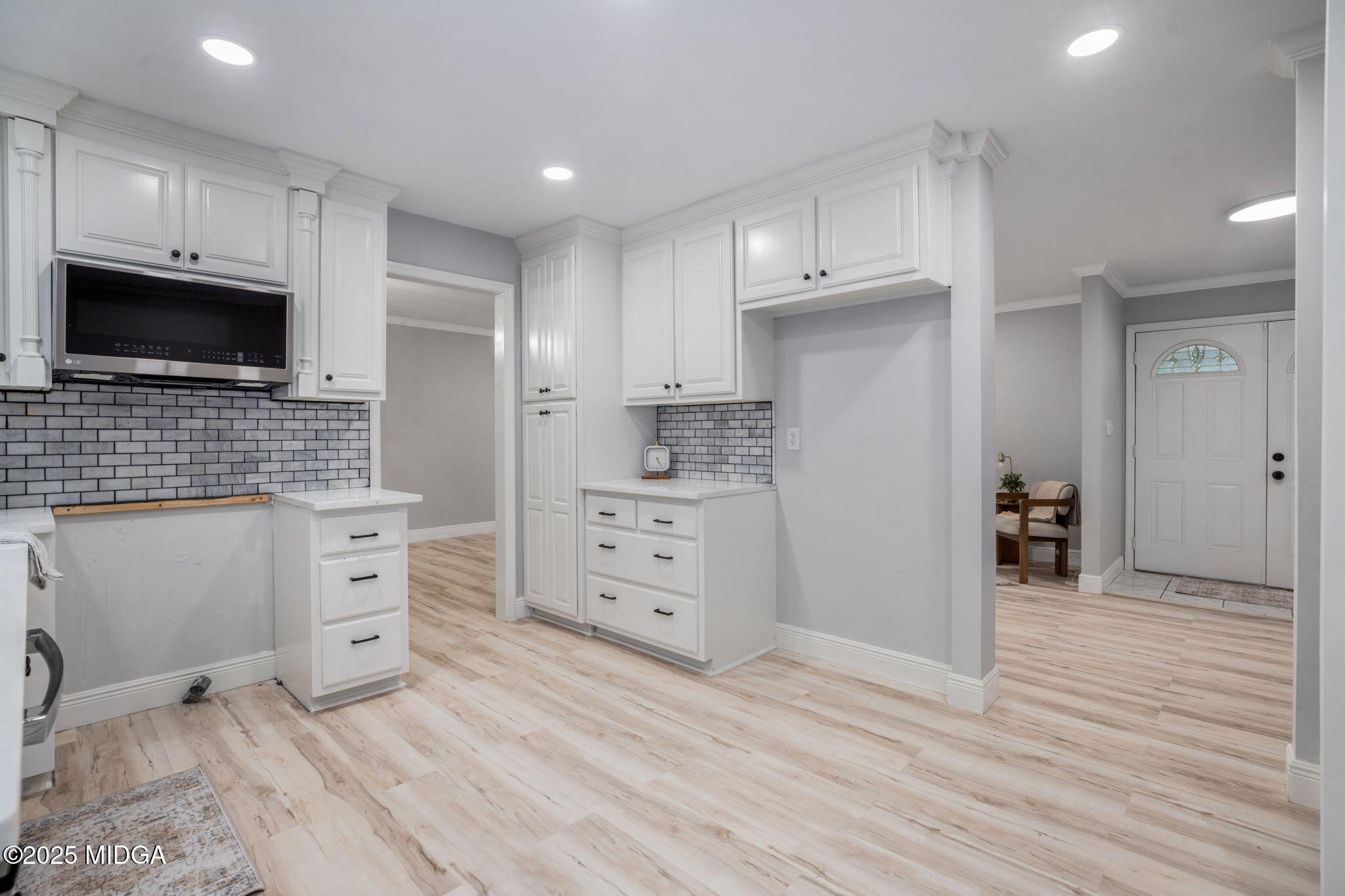 113 Colonial Road Warner Robins, GA 31088 - Photo 11 of 34 a kitchen with white cabinets and stainless steel appliances