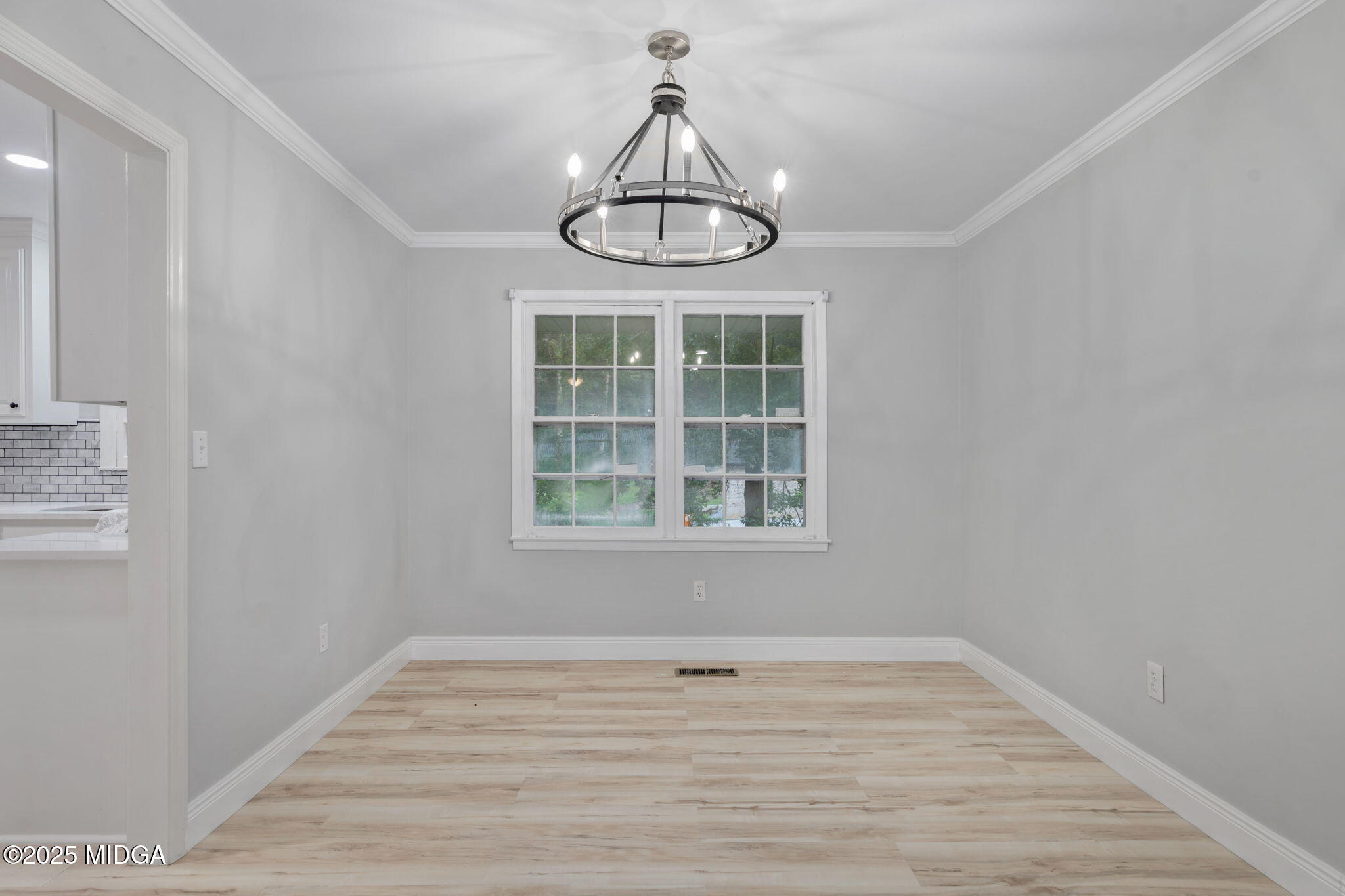 113 Colonial Road Warner Robins, GA 31088 - Photo 13 of 34 a view of an empty room with wooden floor and fan