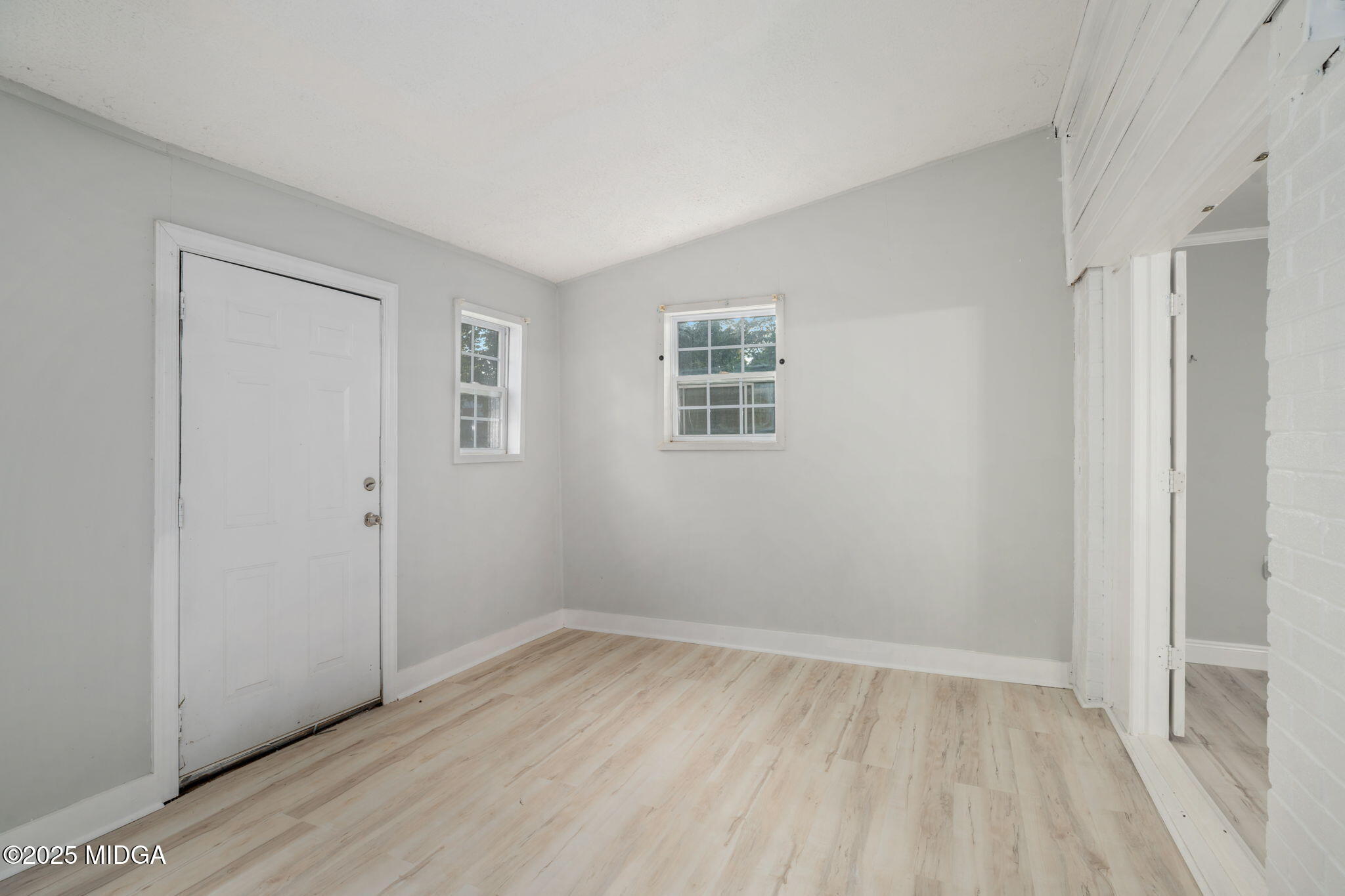 113 Colonial Road Warner Robins, GA 31088 - Photo 29 of 34 a view of an empty room with wooden floor and a window