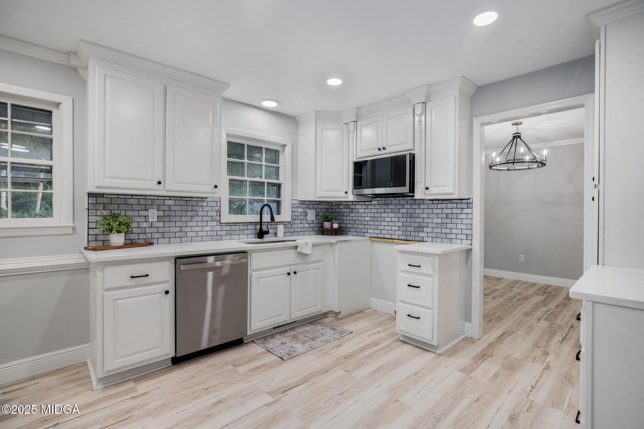 113 Colonial Road Warner Robins, GA 31088 - Photo 10 of 34 a kitchen with stainless steel appliances granite countertop a stove a sink and white cabinets