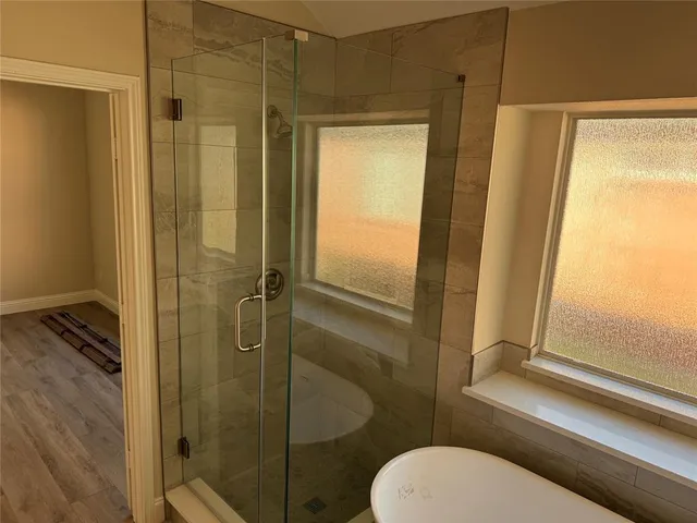a bathroom with a toilet and a shower