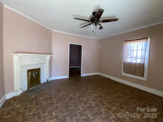 a view of empty room with window and fireplace