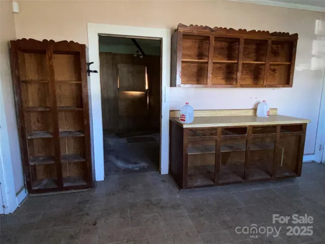 a view of an empty room with a cabinet