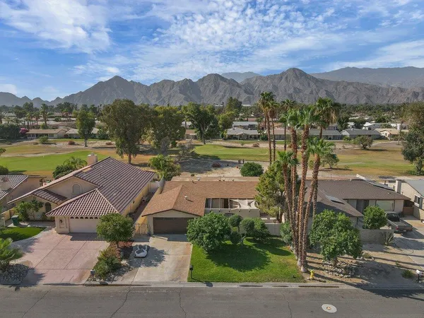 an aerial view of residential houses with outdoor space and river
