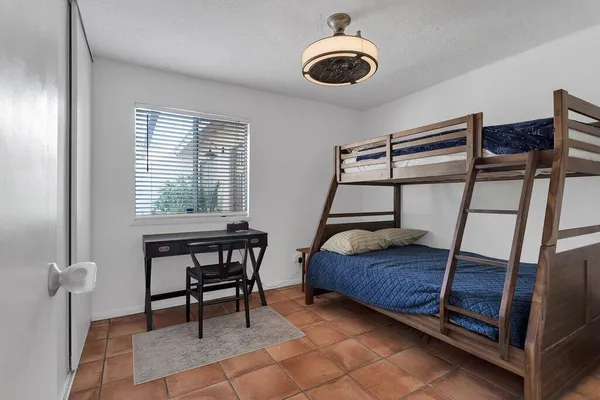 a bedroom with a bed and a chair