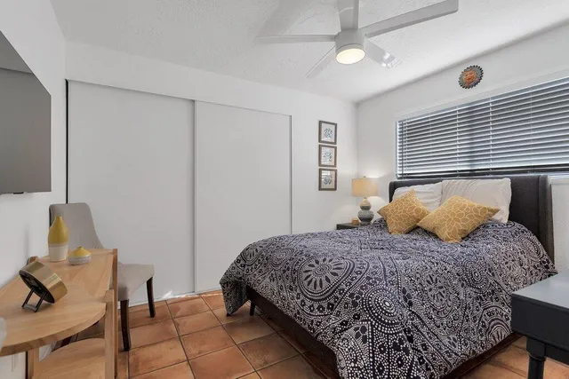 a bedroom with a bed and a table with chair