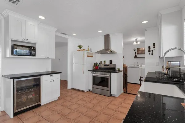 a living room with furniture a fireplace and a chandelier