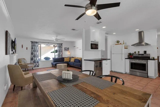 a kitchen with granite countertop a stove top oven cabinets and a refrigerator