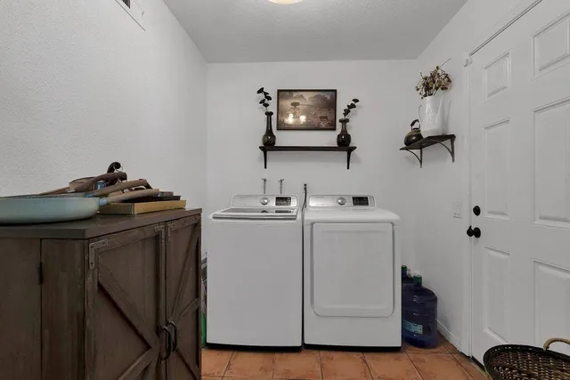 a kitchen with stainless steel appliances granite countertop a stove top oven a sink a dining table and chairs with wooden floor