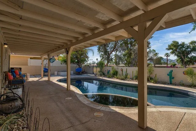 a swimming pool with outdoor seating and yard