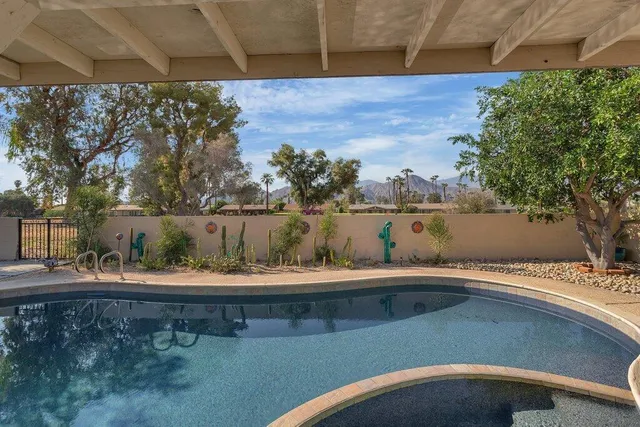 a view of swimming pool with a yard