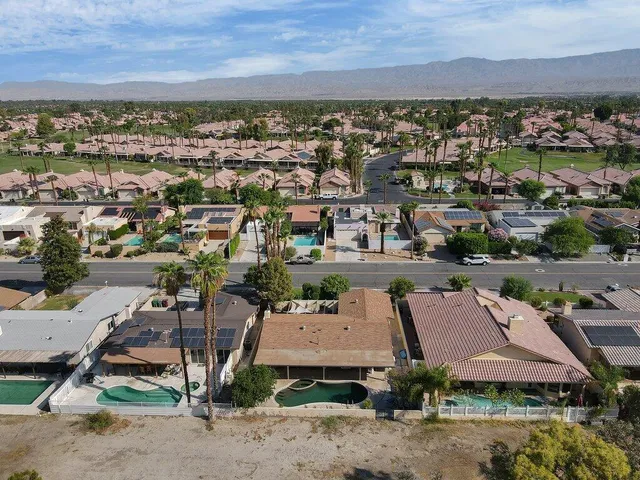 an aerial view of residential houses with outdoor space