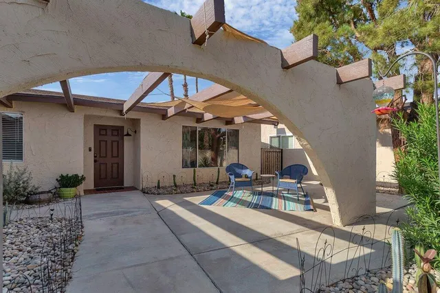 a view of a house with backyard porch and sitting area