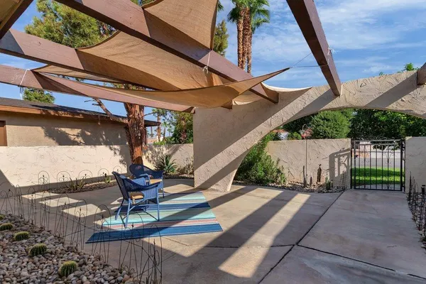 a view of a hallway with wooden floor and a living room