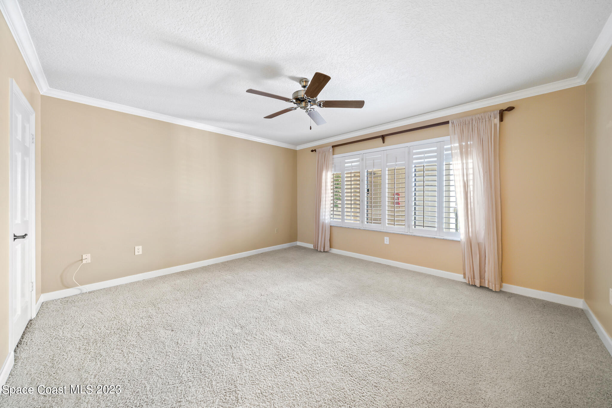2220 Front Street, Unit 303 Melbourne, FL 32901 - Photo 12 of 24 a view of a livingroom with a ceiling fan and window