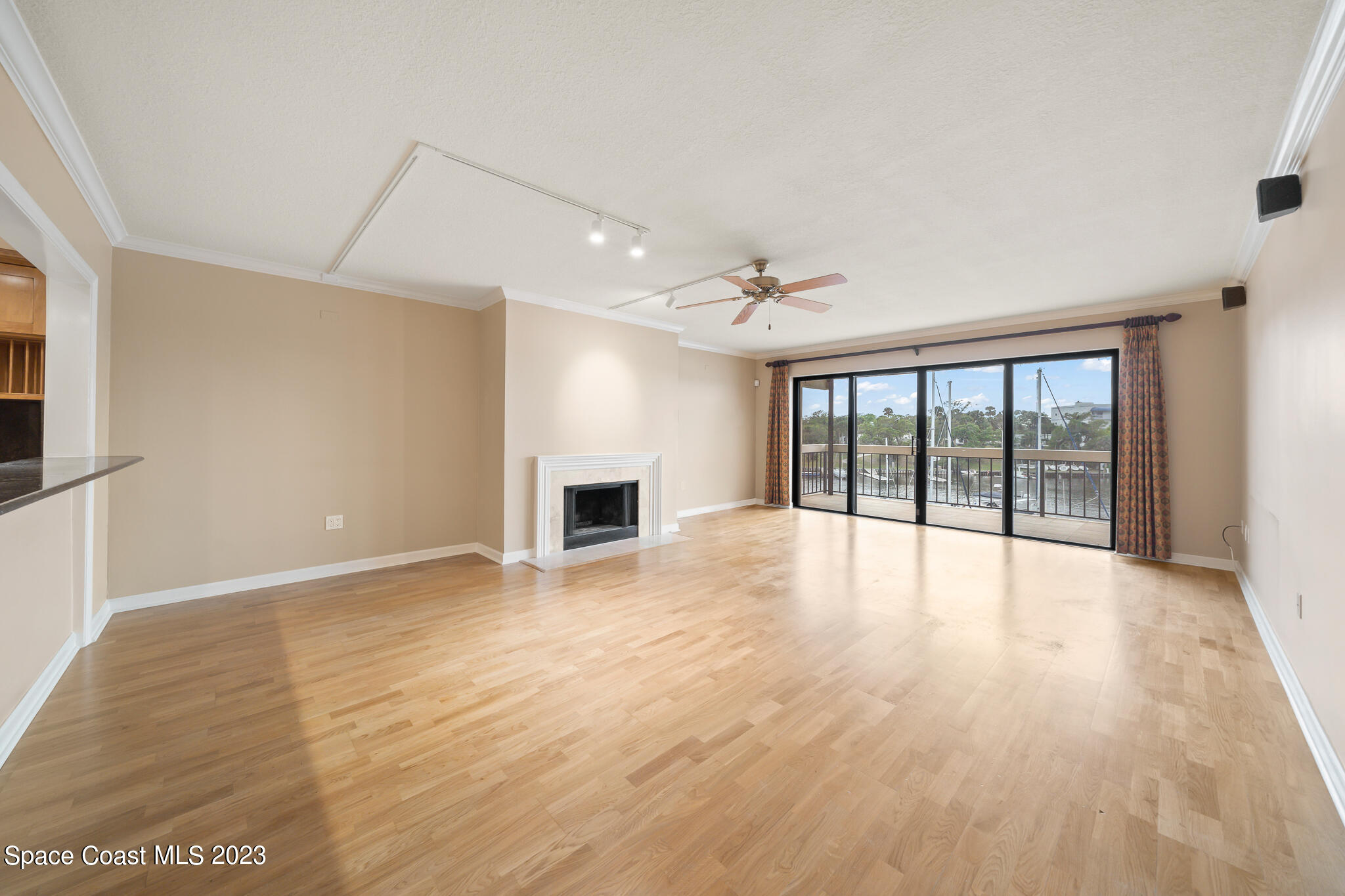 2220 Front Street, Unit 303 Melbourne, FL 32901 - Photo 2 of 24 a view of an empty room with wooden floor and a window