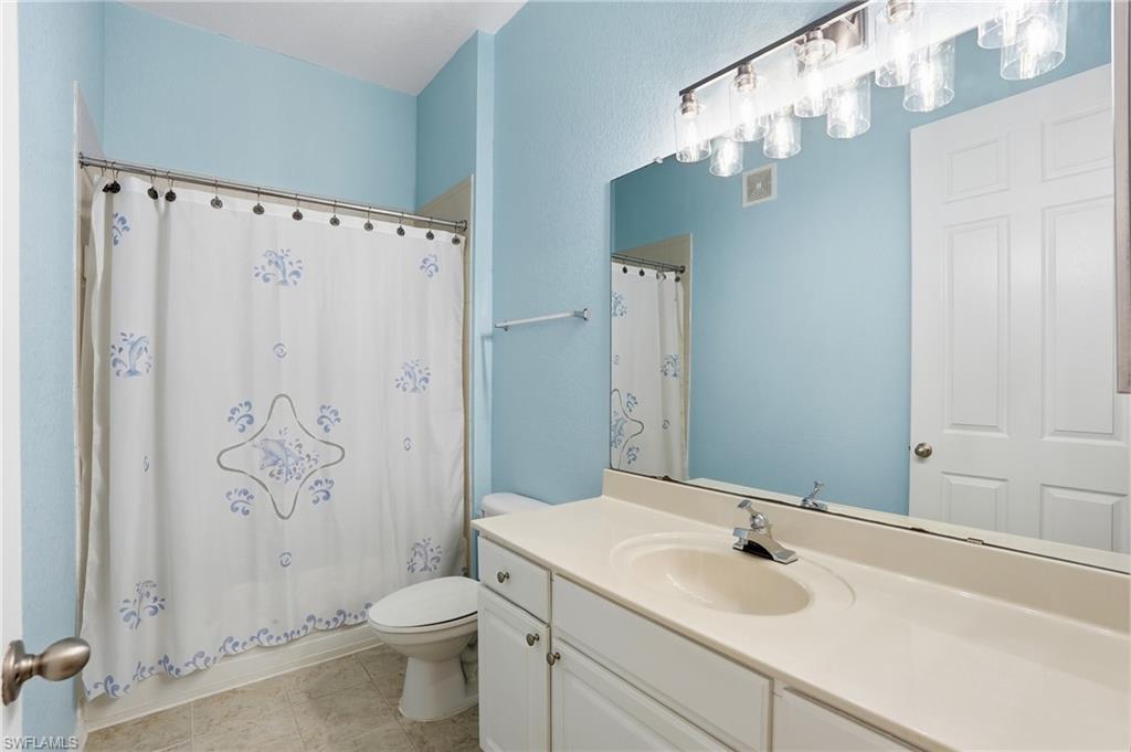 970 Peggy Circle, Unit 604 Naples, FL 34113 - Photo 17 of 24 Full bath featuring vanity, shower / bath combo, and light tile patterned floors