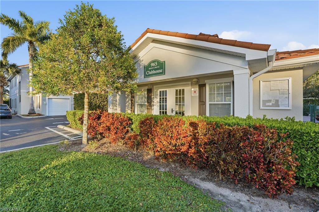 970 Peggy Circle, Unit 604 Naples, FL 34113 - Photo 22 of 24 View of front of property featuring stucco siding