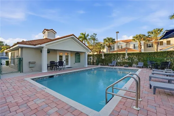 a view of a patio with swimming pool table and chairs
