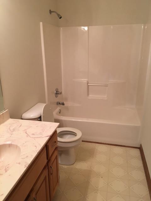 208 Independence Street Springfield, TN 37172 - Photo 10 of 22 a bathroom with a granite countertop sink a toilet and bathtub