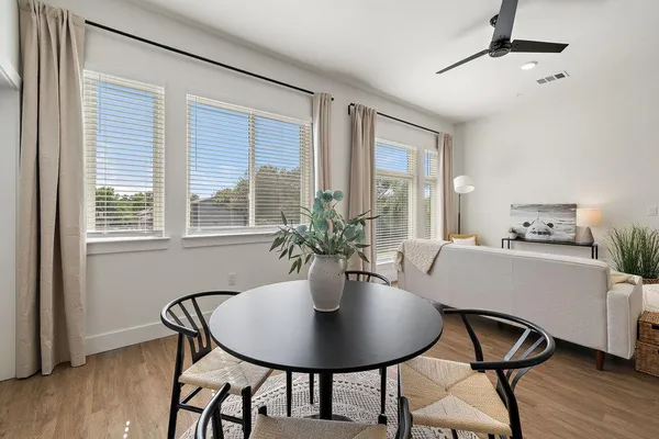 a dining room with furniture and window