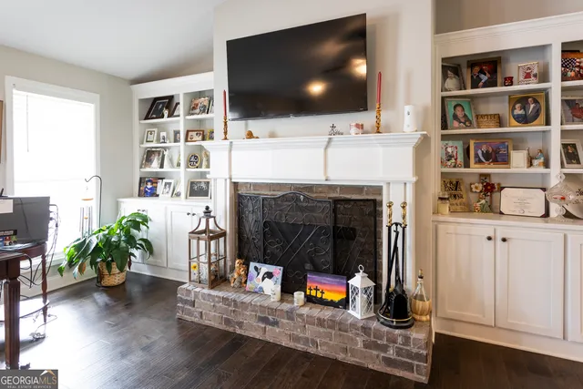 a living room with a flat screen tv and a fireplace