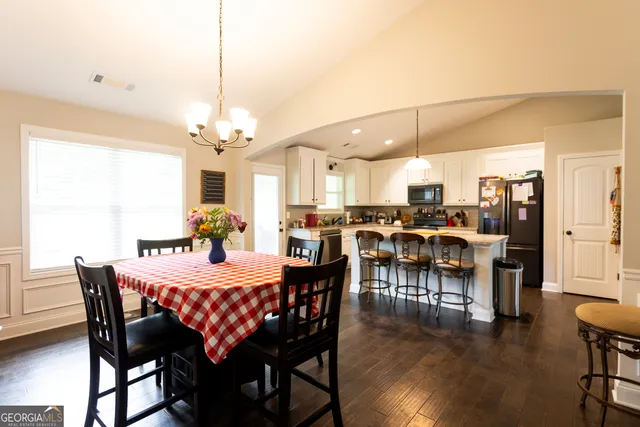 a view of a dining room with furniture and wooden floor