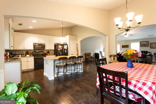 a large kitchen with a table and chairs