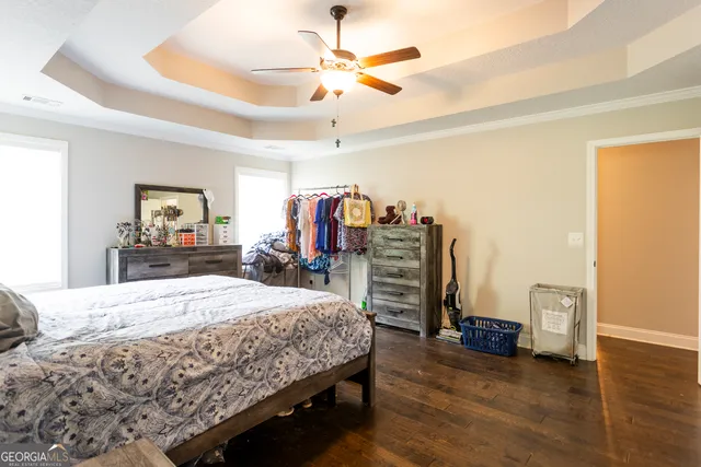 a bedroom with bed and a chandelier