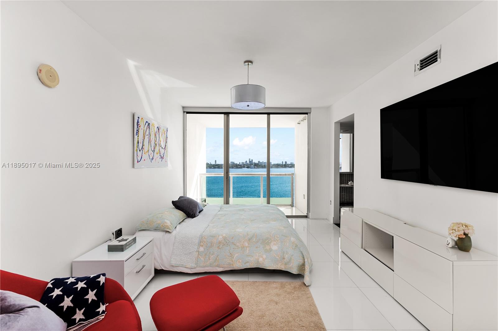 7935 East Drive, Unit 803 Miami Beach, FL 33141 - Photo 19 of 77 a bedroom with a bed and a flat screen tv