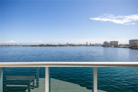 a front view of a building with a garden and plants
