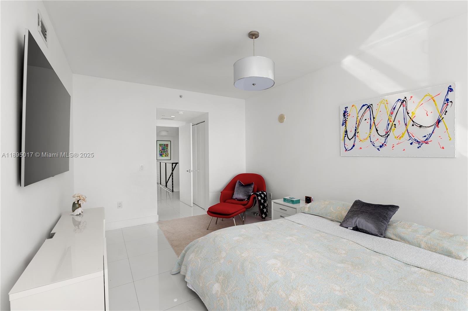 7935 East Drive, Unit 803 Miami Beach, FL 33141 - Photo 68 of 77 a bedroom with a bed and a flat screen tv