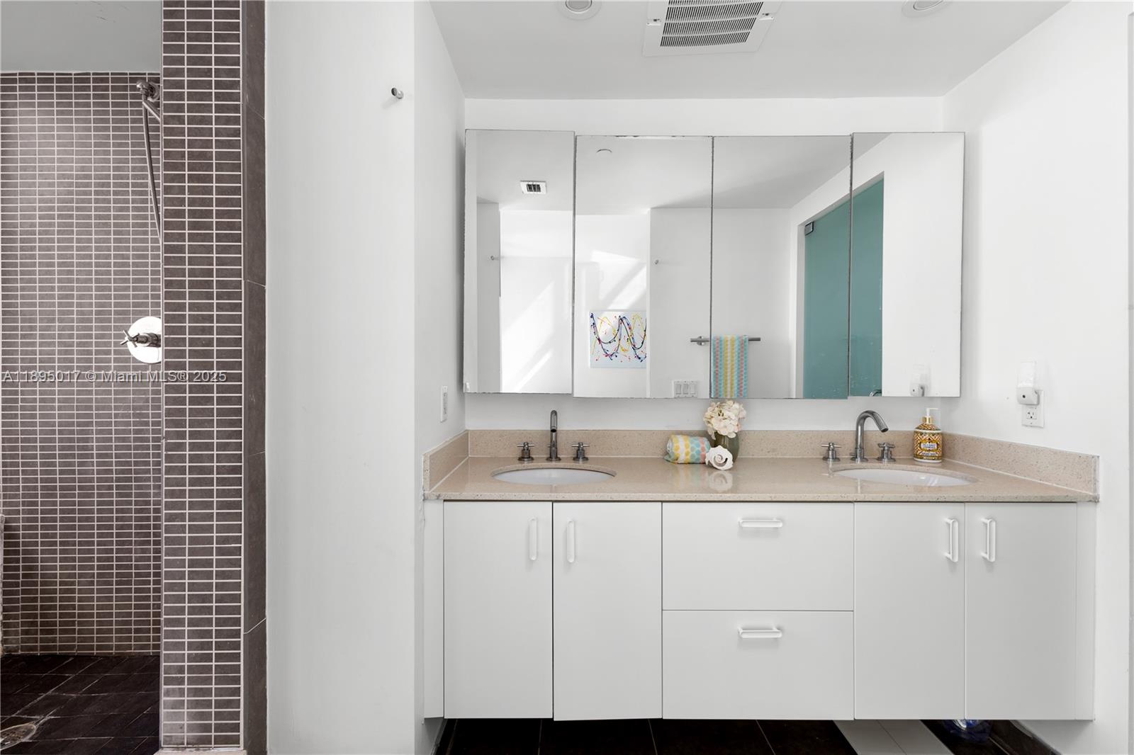 7935 East Drive, Unit 803 Miami Beach, FL 33141 - Photo 71 of 77 a bathroom with a double vanity sink and a mirror