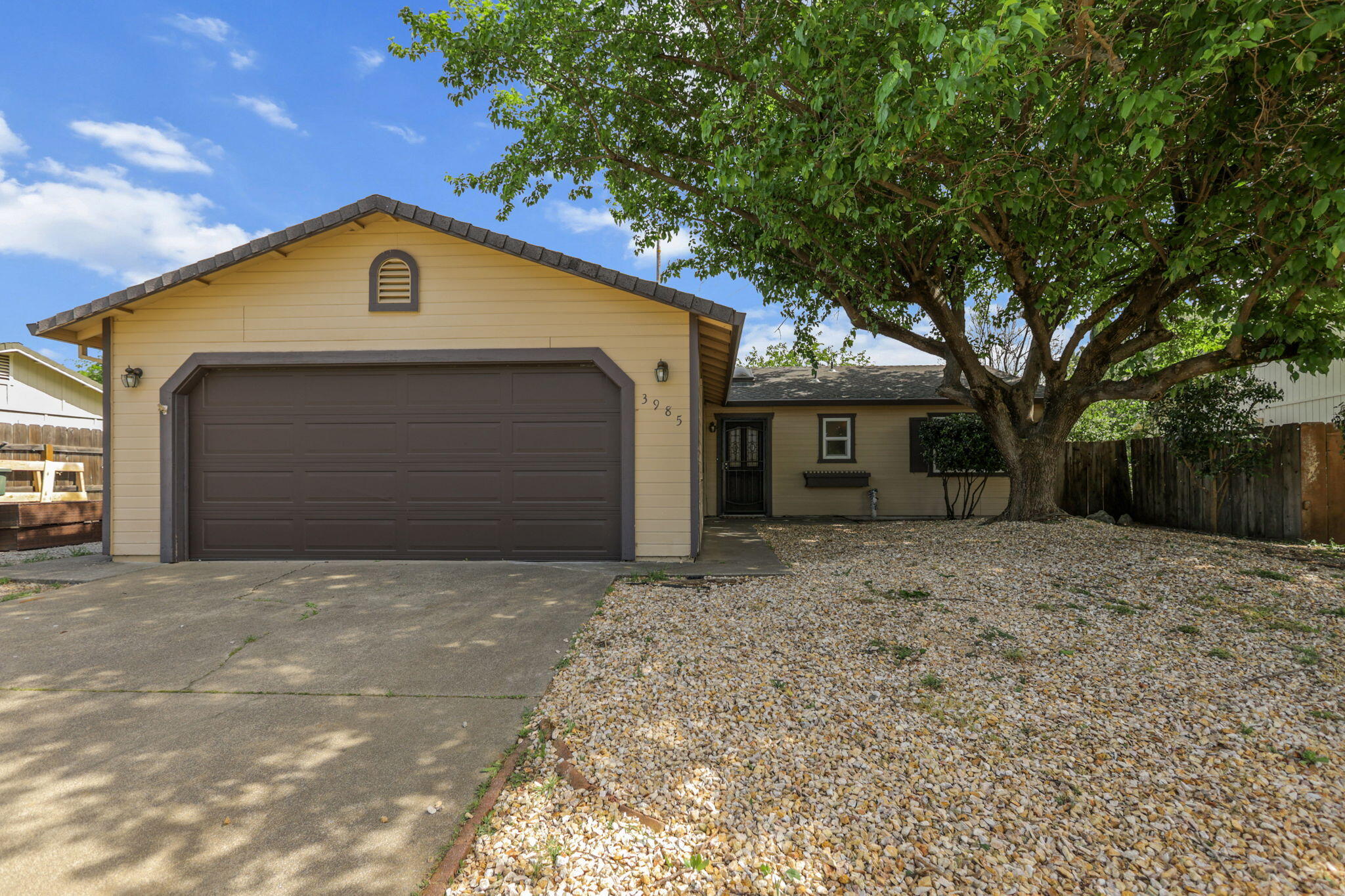 3985 Cirrus Street Redding, CA 96002 - Photo 1 of 27 a front view of a house with a yard and garage