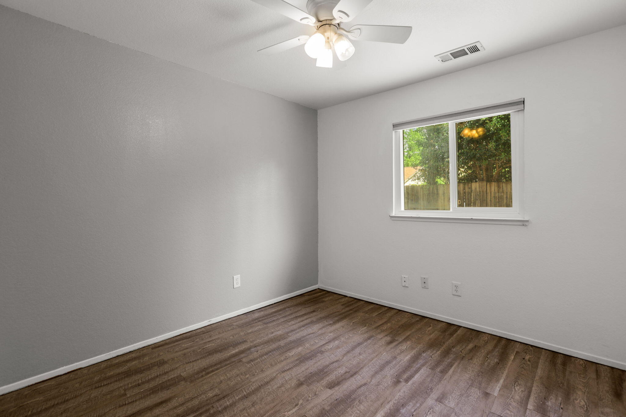 3985 Cirrus Street Redding, CA 96002 - Photo 15 of 27 an empty room with wooden floor and windows