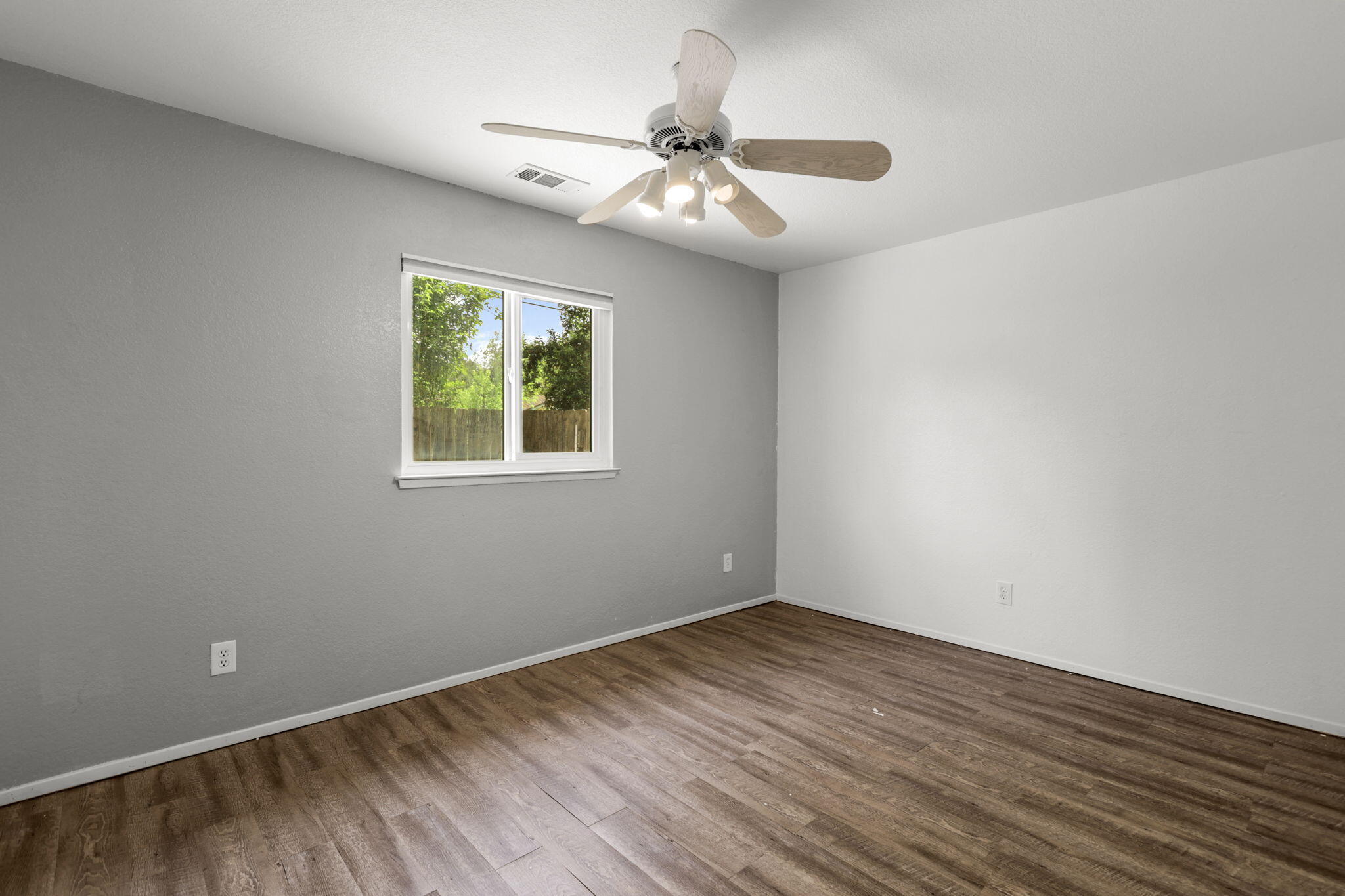 3985 Cirrus Street Redding, CA 96002 - Photo 17 of 27 a view of an empty room with wooden floor and a window