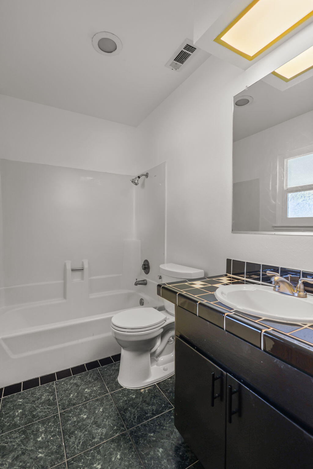 3985 Cirrus Street Redding, CA 96002 - Photo 18 of 27 a bathroom with a sink toilet a mirror and bathtub