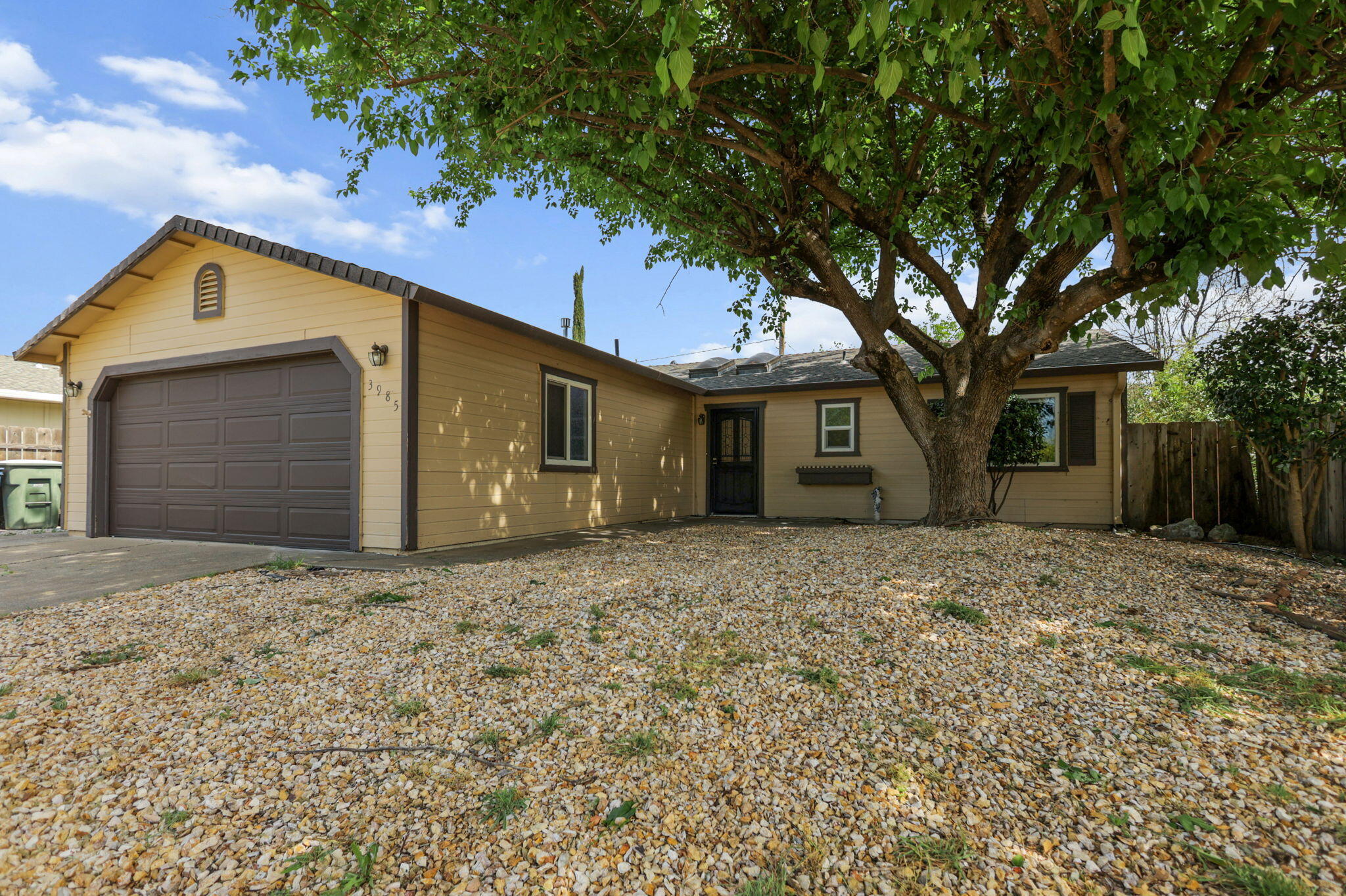 3985 Cirrus Street Redding, CA 96002 - Photo 2 of 27 a front view of a house with a yard and garage